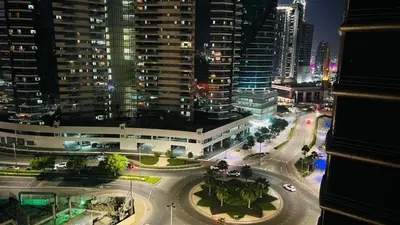 a view of a city at night with buildings at Luxurious Partition Room in Tecom Near Internet City Metro Station in Dubai