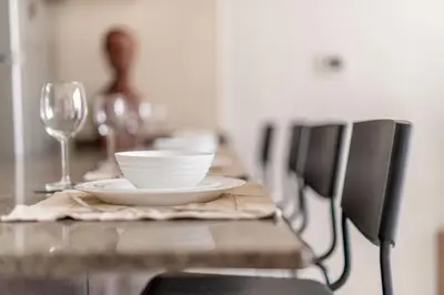 a wooden table with a plate and a glass at GuestReady - Full Marina View at Bay Central in Dubai