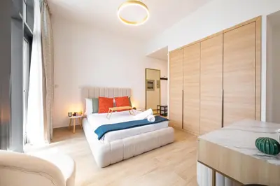 a bedroom with a bed and a couch at Daniels Cozy Studio at JVC in Dubai