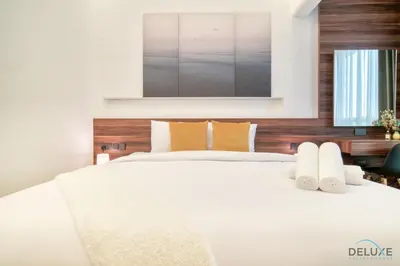 a bedroom with a large white bed with a mirror above it at Modern 1BR at Marina Park Dubai Marina by Deluxe Holiday Homes in Dubai