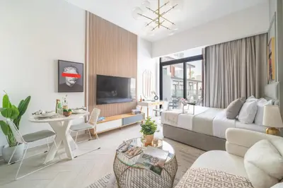 a living room with a bed and a table at Frank Porter - Oxford 212 in Dubai