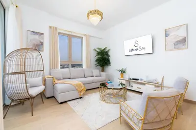 a living room with a couch and chairs at Ultimate Stay Port de La Mer with Burj Khalifa Views from the Bed next to the Beach in Dubai