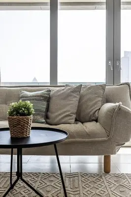 a living room with a couch and a table at Spacious Studio in Downtown I 8 Boulevard Walk in Dubai