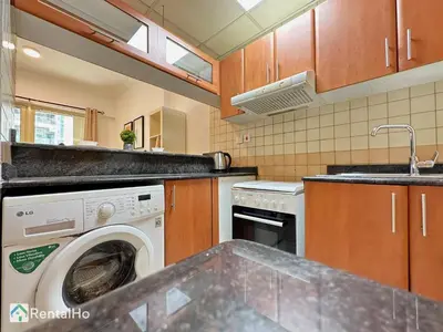 a kitchen with a washing machine and a sink at Quiet Studio with Balcony and Roof Top Pool in Dubai Marina in Dubai
