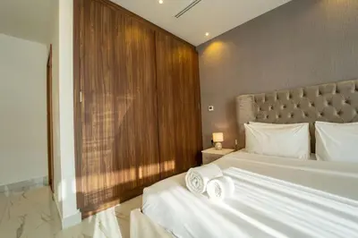 a bedroom with a large bed with white pillows at AWS Holiday Homes - Luxurious 2BR in Business Bay in Dubai