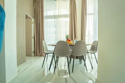 a dining room with a table and chairs in a room at AWS Holiday Homes - Luxurious 2BR in Business Bay in Dubai
