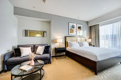 a hotel room with a bed and a couch at Magnificent apartment in Emaar Dubai Marina in Dubai
