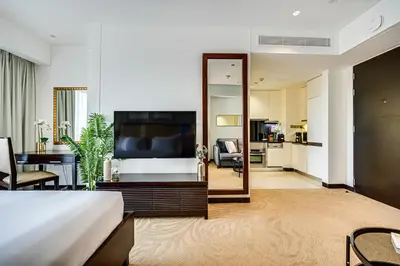 a hotel room with a bed and a large mirror at Magnificent apartment in Emaar Dubai Marina in Dubai