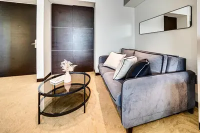 a living room with a couch and a glass table at Magnificent apartment in Emaar Dubai Marina in Dubai