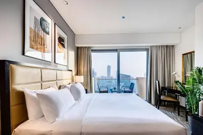 a hotel room with a large bed and a balcony at Magnificent apartment in Emaar Dubai Marina in Dubai