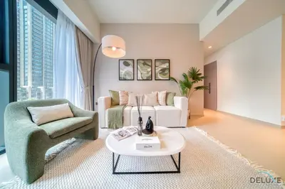 a living room with a couch and a chair and a table at Sumptuous 1BR at Act One Act Two Tower 1 Downtown Dubai by Deluxe Holiday Homes in Dubai