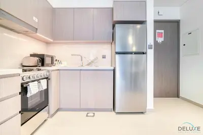 a kitchen with a stainless steel refrigerator at Sumptuous 1BR at Act One Act Two Tower 1 Downtown Dubai by Deluxe Holiday Homes in Dubai