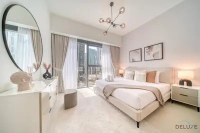 a white bedroom with a large bed and a mirror at Sumptuous 1BR at Act One Act Two Tower 1 Downtown Dubai by Deluxe Holiday Homes in Dubai