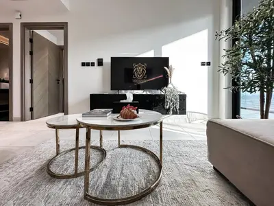 a living room with a coffee table and a couch at Trophy Sunny Honey Suite Canal View & Infinty Pool in Dubai