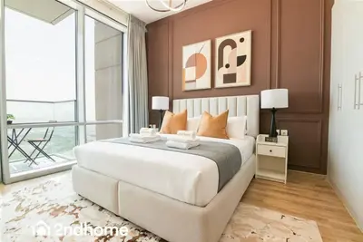 a bedroom with a large bed and a large window at 2ndHome - Amna Tower, Al Habtoor City in Dubai
