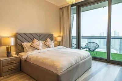 a bedroom with a large bed with a large window at Downtown 3BR Luxe, Burj & Fountain View Bliss Near Dubai Mall in Dubai