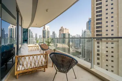 a balcony with chairs and a view of the city at GuestReady - Lux home with sea view balcony in Dubai