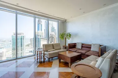 a living room with a couch and chairs and windows at GuestReady - Lux home with sea view balcony in Dubai