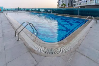 a swimming pool with a slide in a building at Group Stay I Near Dubai Mall I Family friendly in Dubai