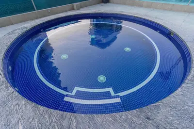 a blue swimming pool with stairs in the water at Group Stay I Near Dubai Mall I Family friendly in Dubai