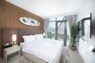 a bedroom with a large white bed and a large window at Chic Palm Studio with Sea View & Infinity Pool in Dubai