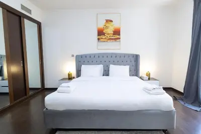 a bedroom with a large bed with white sheets at MURJAN JBR Apartments by HAPPY SEASON in Dubai