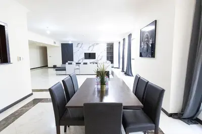 a dining room with a table and chairs at MURJAN JBR Apartments by HAPPY SEASON in Dubai