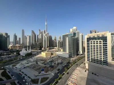 a city with a lot of traffic and buildings at Manzil - Cozy Studio nr Downtown w Canal Views in Dubai