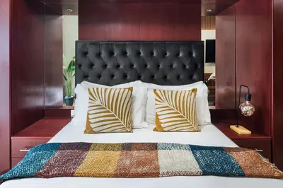 a bedroom with a bed with a black headboard and pillows at Furnished Apartment for Rent in Saba 3, JLT in Dubai