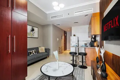 a kitchen and living room with a table in a room at Furnished Apartment for Rent in Saba 3, JLT in Dubai