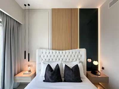a bedroom with a large white bed with two pillows at Trophy - Downtown Skyview Residence in 35th floor in Dubai