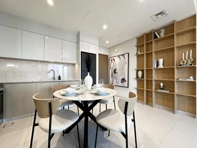 a kitchen and dining room with a table and chairs at Trophy - Downtown Skyview Residence in 35th floor in Dubai