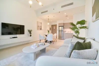 a living room with a white couch and a table at Plush 1BR at Act One Act Two Tower 2 Downtown Dubai by Deluxe Holiday Homes in Dubai