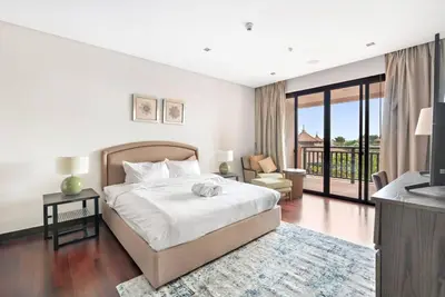 a bedroom with a large bed and a balcony at StoneTree - Anantara South Residences 2 BR - Palm Jumeirah in Dubai