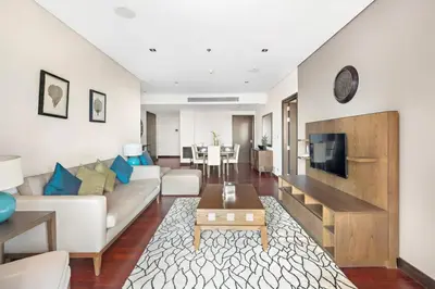a living room with a white couch and a tv at StoneTree - Anantara South Residences 2 BR - Palm Jumeirah in Dubai