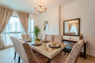 a dining room with a table and chairs at INA HOMES - Residences Tower 1 Upper Floor in Dubai