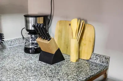 two wooden cutting boards sitting on top of a counter at Modern Silicon Oasis Studio Near Academic City in Dubai