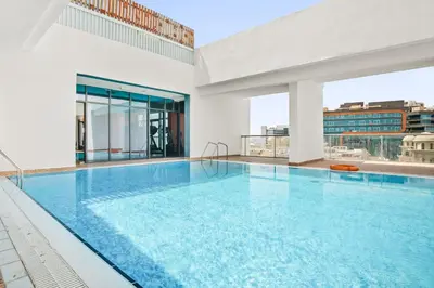 a swimming pool on the roof of a building at Modern Silicon Oasis Studio Near Academic City in Dubai