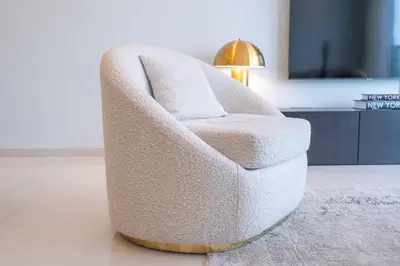 a white chair in a living room with a lamp at Stylish 2Bedroom w infinity pool on the 64th floor in Dubai