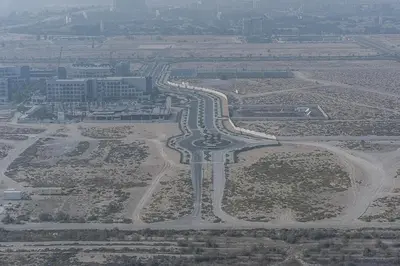 an aerial view of a city with a highway at Floral Charm studio in Damac Hills by Suiteable in Dubai