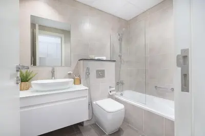 a bathroom with a sink and a toilet and a shower at Floral Charm studio in Damac Hills by Suiteable in Dubai