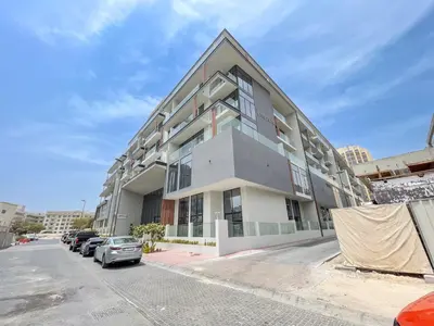 a large building with cars parked in front of it at Relax & Recharge Studio Loft with hanging net in Dubai