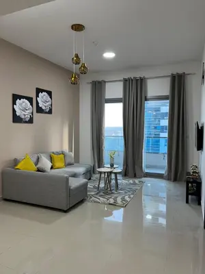 a living room with a couch and a table at Holiday Rental in Dubai