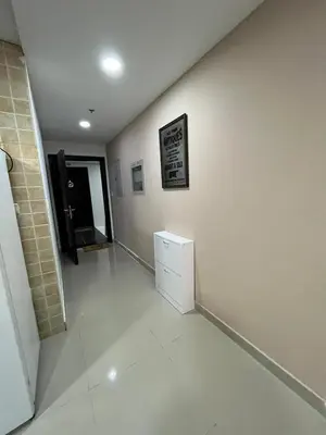 a room with a white wall and a white cabinet at Holiday Rental in Dubai