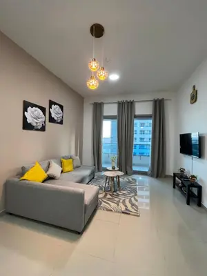 a living room with a couch and a tv at Holiday Rental in Dubai