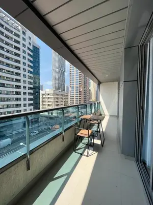 a balcony with a table and chairs on a building at Holiday Rental in Dubai