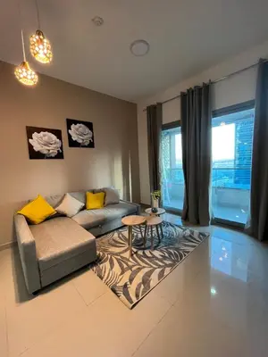 a living room with a couch and a table at Holiday Rental in Dubai
