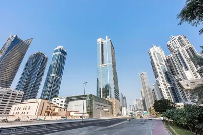 a street in a city with tall buildings at StoneTree - Paramount 3BR - Panoramic View in Dubai