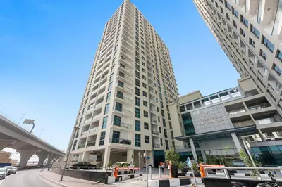 a tall white building on a city street at StoneTree - DEC Tower 2 Studio - Dubai Marina in Dubai