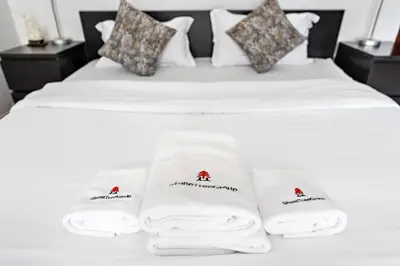 a bed with white towels and pillows on it at StoneTree - DEC Tower 2 Studio - Dubai Marina in Dubai